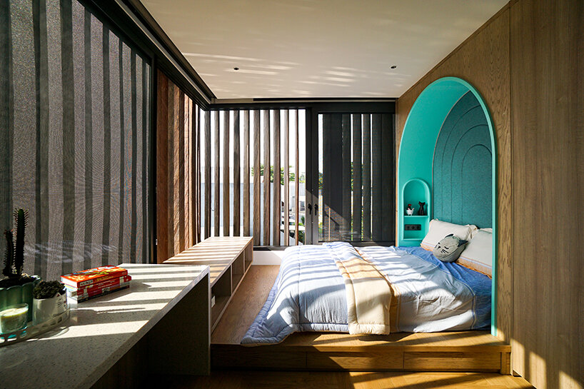 grass, stones, shrubs, and trees envelop studioRK's vibrant OHIO house in indonesia