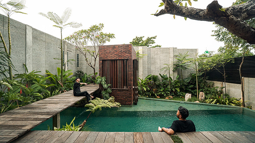 grass, stones, shrubs, and trees envelop studioRK's vibrant OHIO house in indonesia