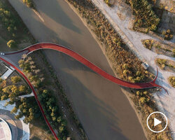 china's winding theatre park bridge echoes its natural environment & the lotus architecture