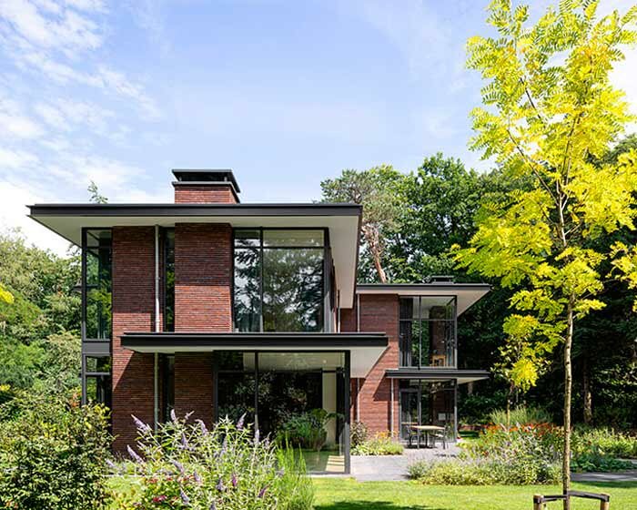 red brick facade and steel fascias form villa trompenberg in the netherlands