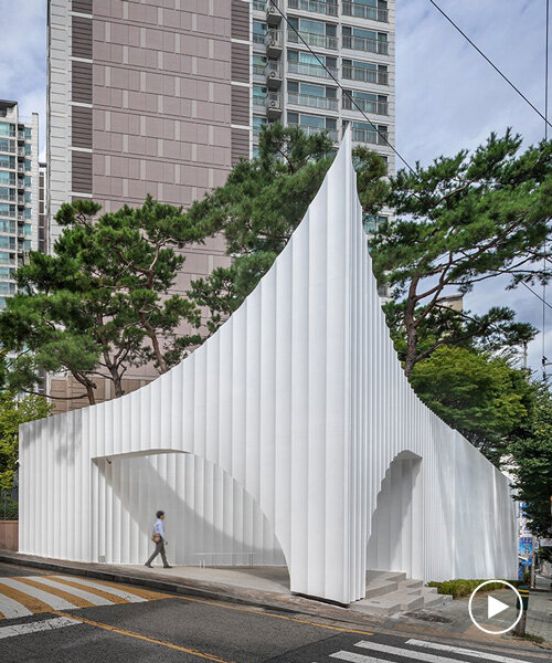 corrugated white wing pavilion forms apartment block entrance gate in south korea