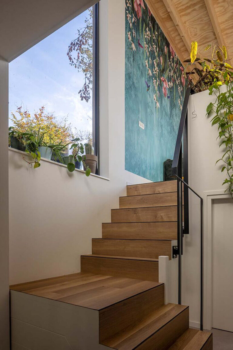 floating wooden houseboat by EVA architecten embraces canal views in utrecht