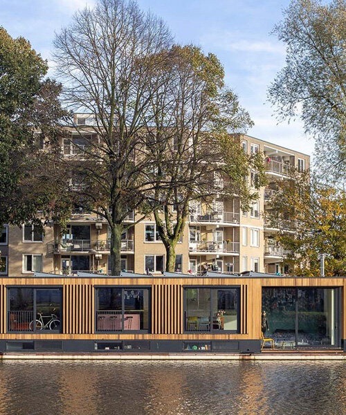floating wooden houseboat by EVA architecten embraces canal views in utrecht