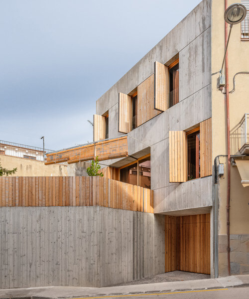 contemporary 'casa nus' is wedged into the historic streets of olot, spain