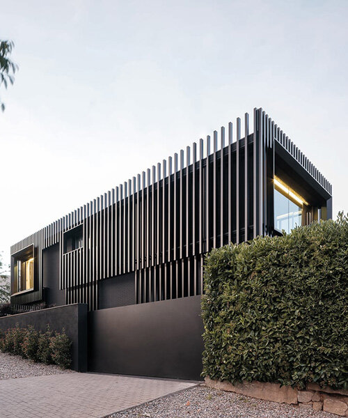 black monochrome envelope and vertical steel slats modernize family home in barcelona