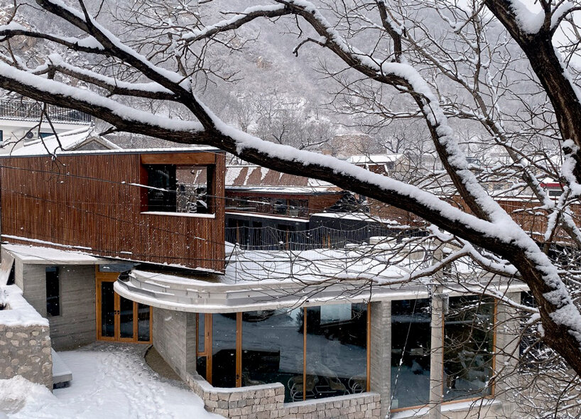 bending wooden bridge by DL atelier hovers above historical chinese fortress
