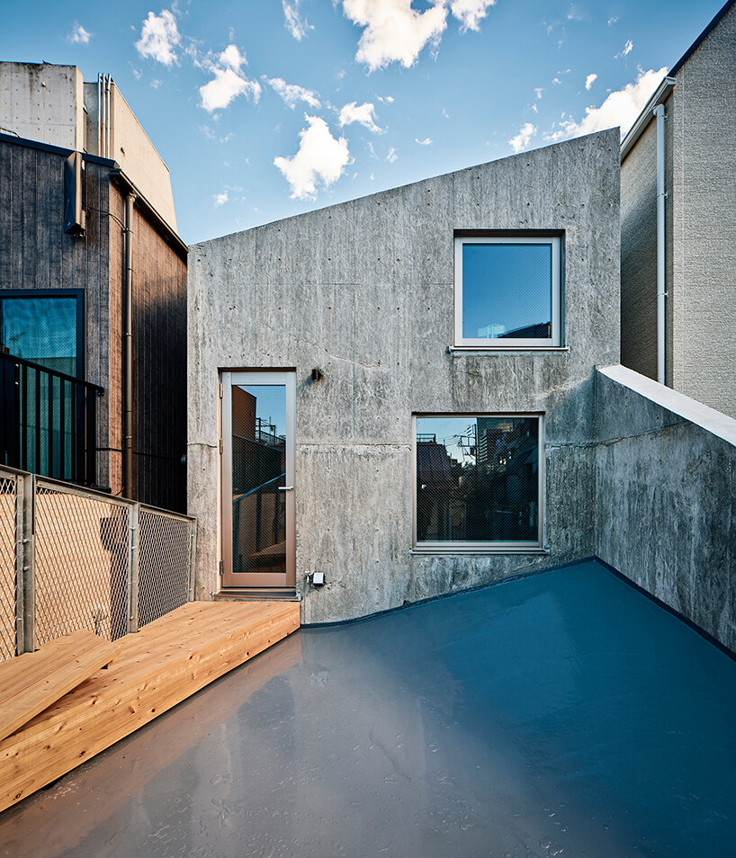 slanted lines and staggered floors create alternative spaces inside tokyo's diagonal house