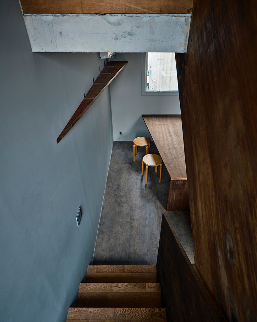 slanted lines and staggered floors create alternative spaces inside tokyo's diagonal house
