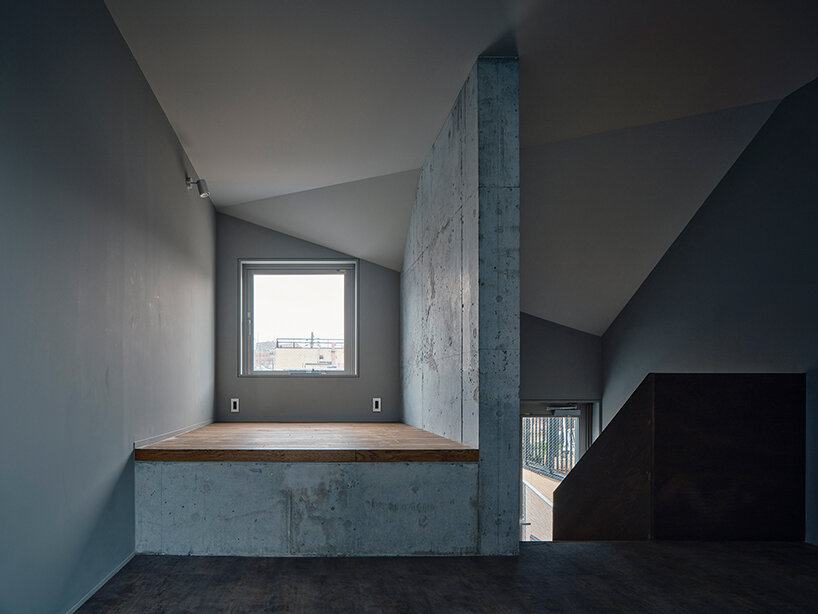 slanted lines and staggered floors create alternative spaces inside tokyo's diagonal house