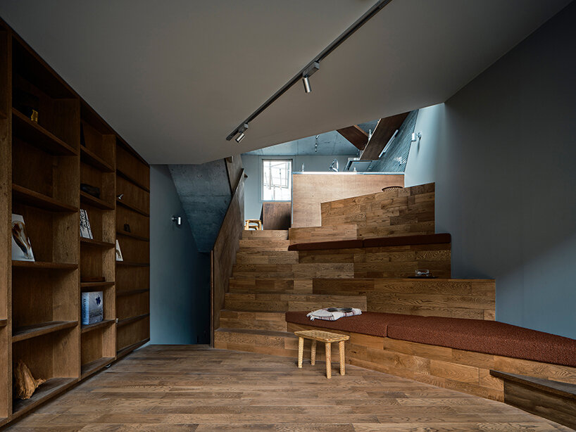 slanted lines and staggered floors create alternative spaces inside tokyo's diagonal house