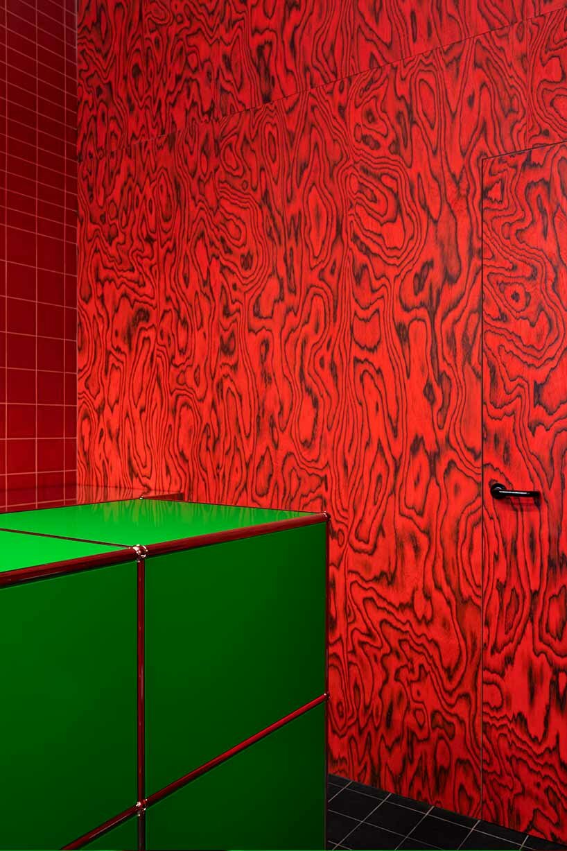 glossy red tiles contrast with lime green counter within spazio maiocchi's new bar in milan