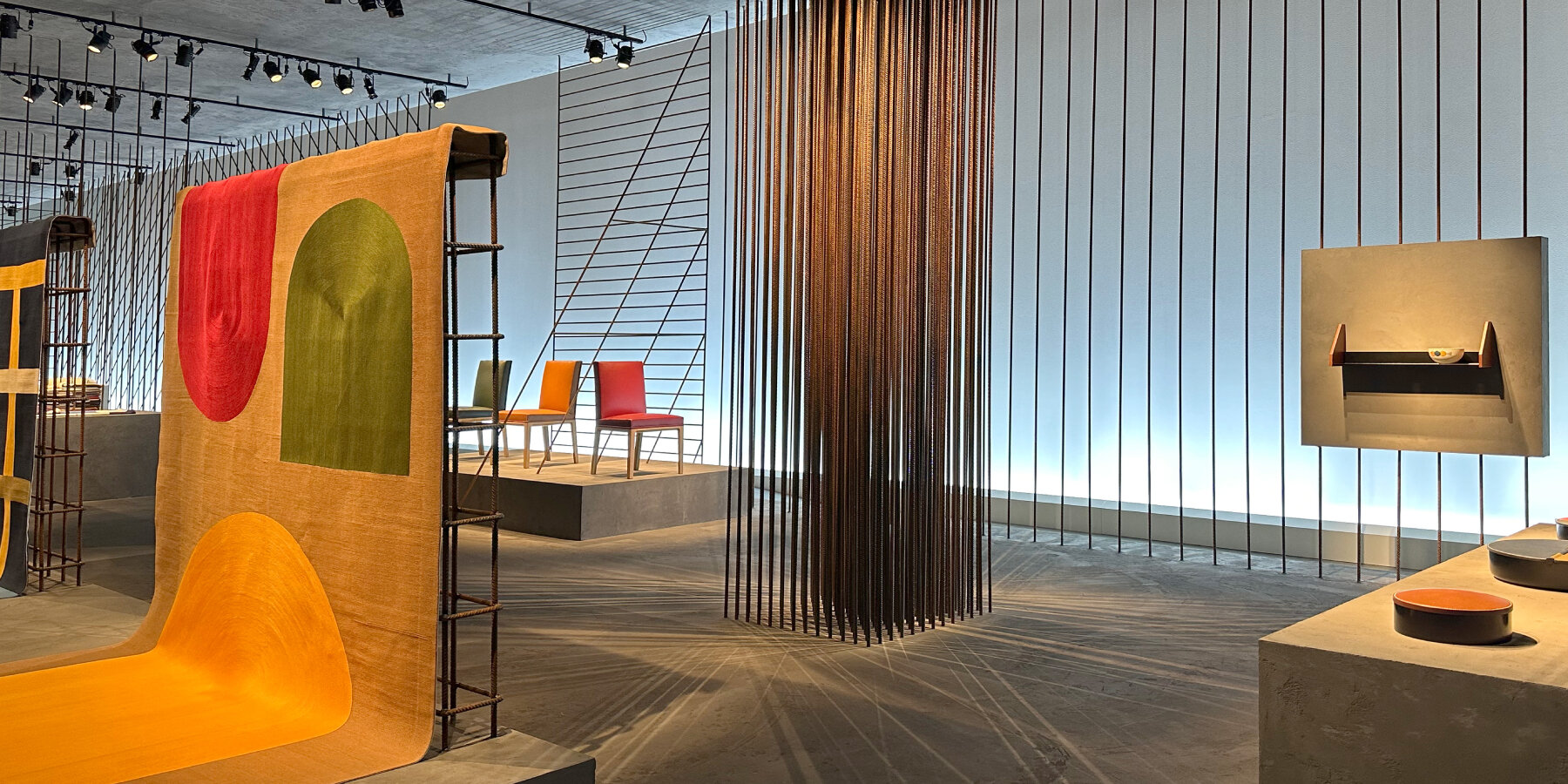 interview: Hermès encloses new home collections in transparent iron rod  installation in milan