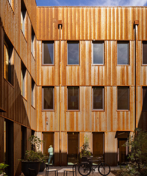 all-wood mass timber building in portland, oregon is wrapped in a steel 'rain jacket'