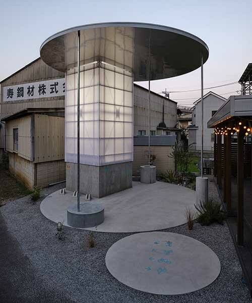 clad in milky-white corrugated panels, this japanese public restroom emits soft light