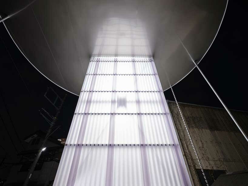 clad in milky-white corrugated panels, this japanese public restroom emits soft light