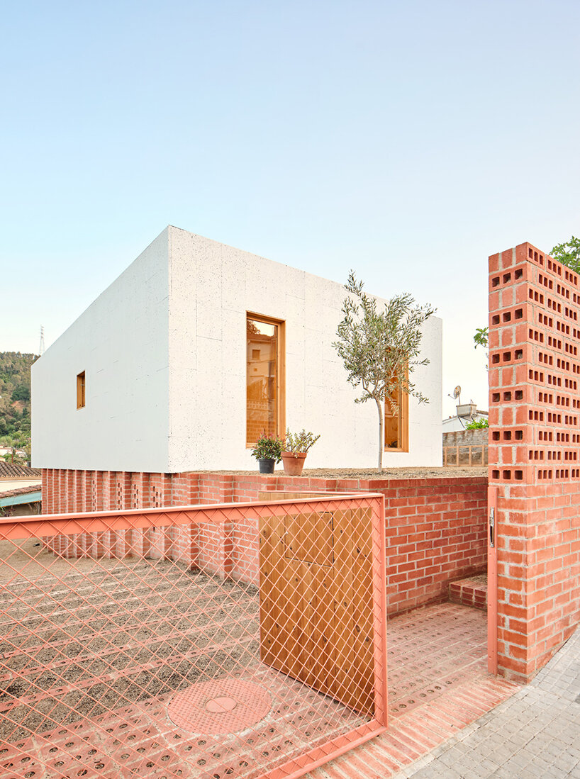 ágora arquitectura se apila en una casa de tablillas encima de un viejo zócalo de ladrillo en España