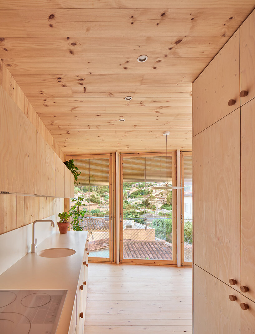 ágora arquitectura stacks cross laminated timber house atop old brick base in spain