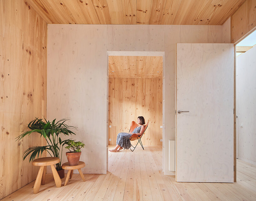 ágora arquitectura stacks cross laminated timber house atop old brick base in spain
