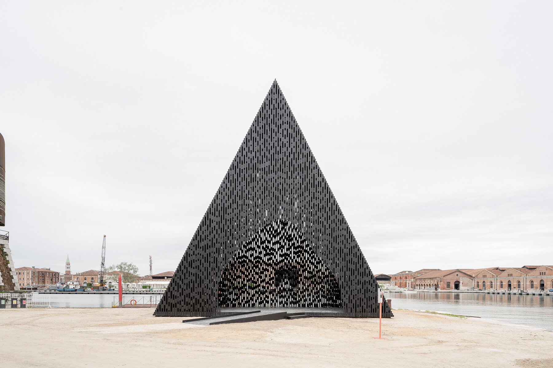 david adjaye shapes kwaeε pavilion as triangular timber prism at venice