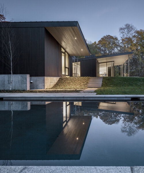 desai chia architects weaves the landscape into its blackened timber roxbury house