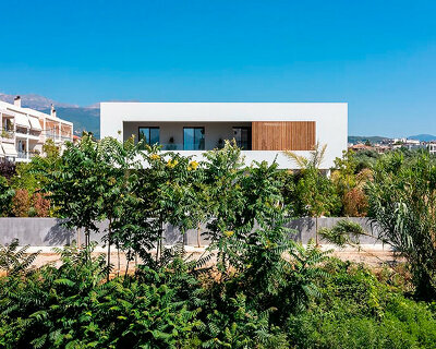 circular roof aperture sheds light through 'frame house' in greece