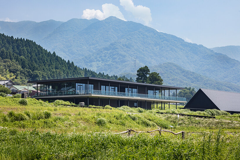 furuya design weaves underground sake brewery into the lush landscape of fukui, japan