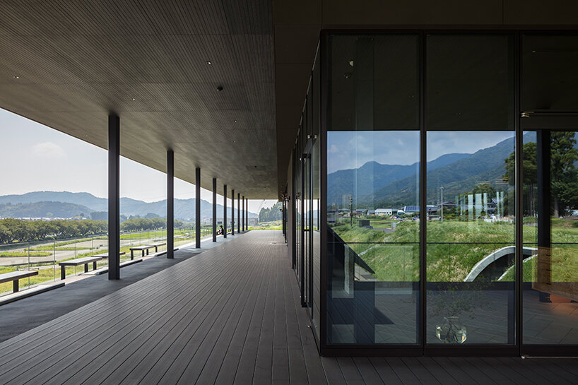 furuya design weaves underground sake brewery into the lush landscape of fukui, japan