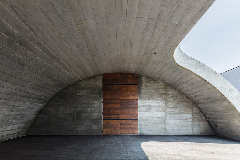 furuya design weaves underground sake brewery into the lush landscape of fukui, japan