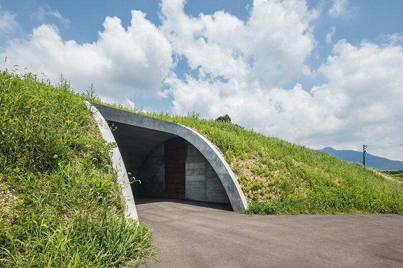 furuya design weaves underground sake brewery into the lush landscape of fukui, japan