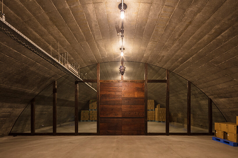 furuya design weaves underground sake brewery into the lush landscape of fukui, japan