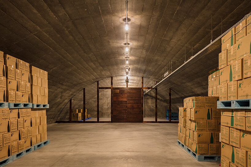 furuya design weaves underground sake brewery into the lush landscape of fukui, japan