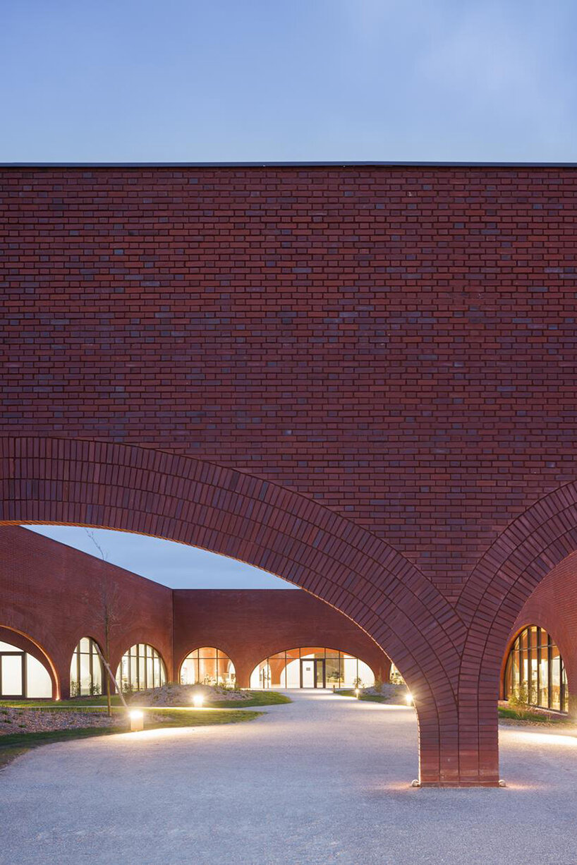 lina ghotmeh brings sweeping arches to brick-clad hermès workshop in normandy