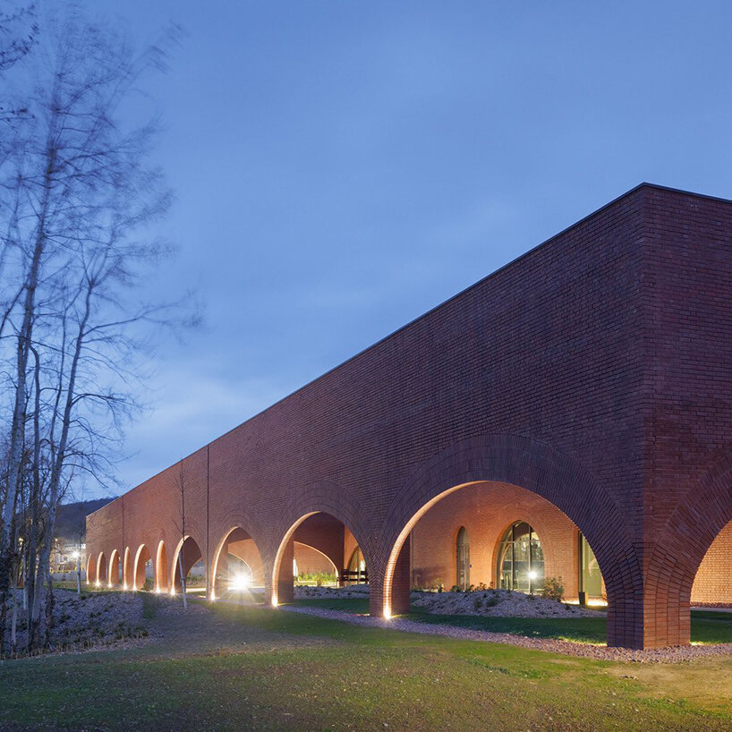 lina ghotmeh brings sweeping arches to brick-clad hermès workshop in normandy