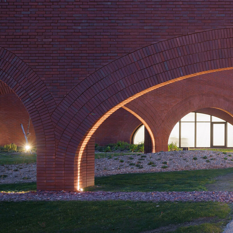 lina ghotmeh brings sweeping arches to brick-clad hermès workshop in normandy