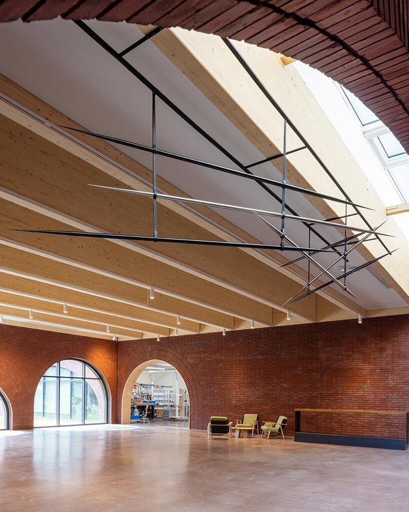 lina ghotmeh brings sweeping arches to brick-clad hermès workshop in normandy