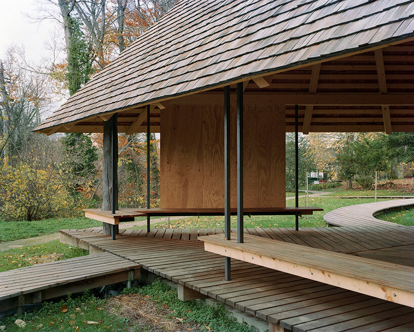 charly jolliet's umbrella-shaped canopy in switzerland spotlights traditional wood cladding