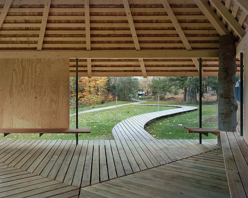 charly jolliet's umbrella-shaped canopy in switzerland spotlights traditional wood cladding