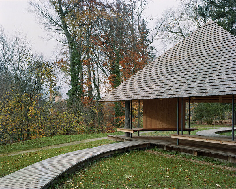 charly jolliet's umbrella-shaped canopy in switzerland spotlights traditional wood cladding