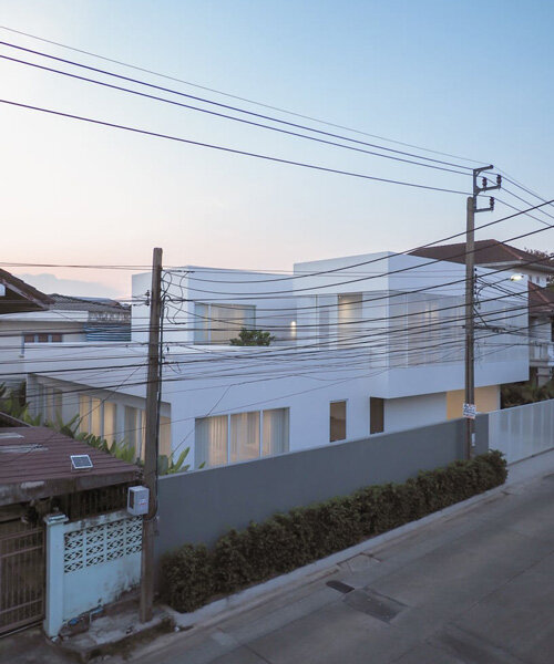 translucent volumes encircle a core courtyard at this multi-generational home in bangkok