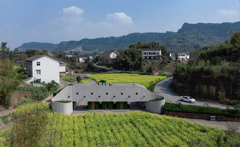 folded agricultural complex doubles as bridge and public toilet in rural china
