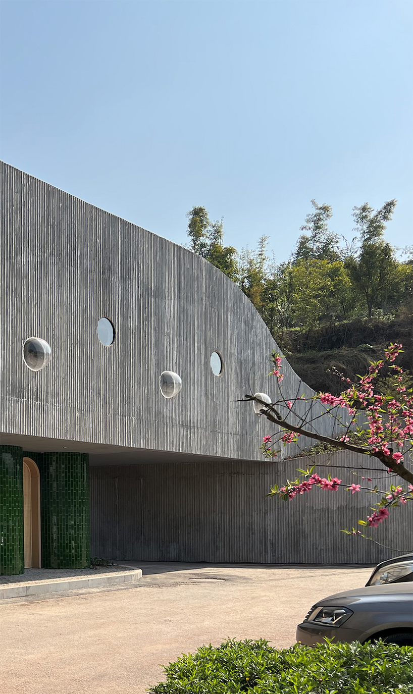 folded agricultural complex doubles as bridge and public toilet in rural china