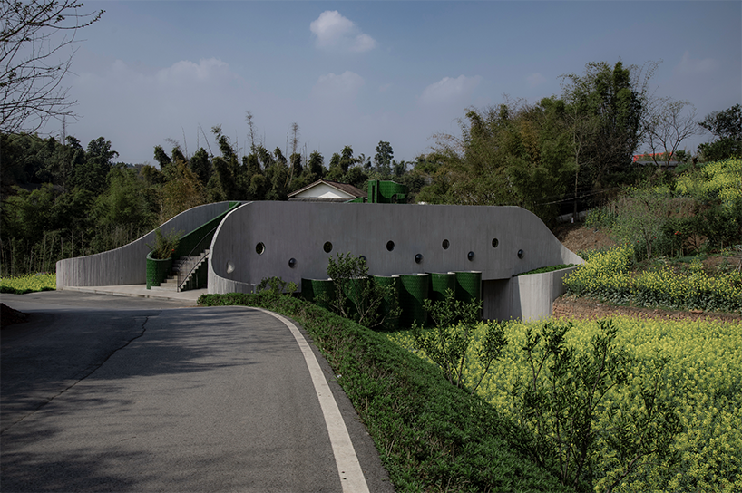 folded agricultural complex doubles as bridge and public toilet in rural china