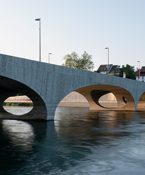 christ & gantenbein complements swiss riverside with gently arched concrete bridge