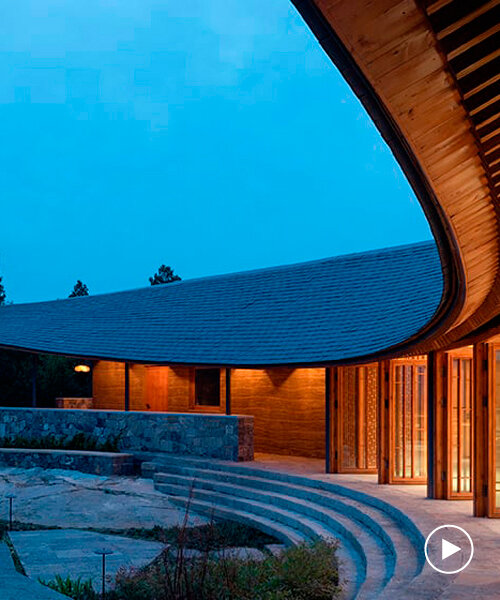 restaurant's gentle curvilinear form encompasses ancient temple in china