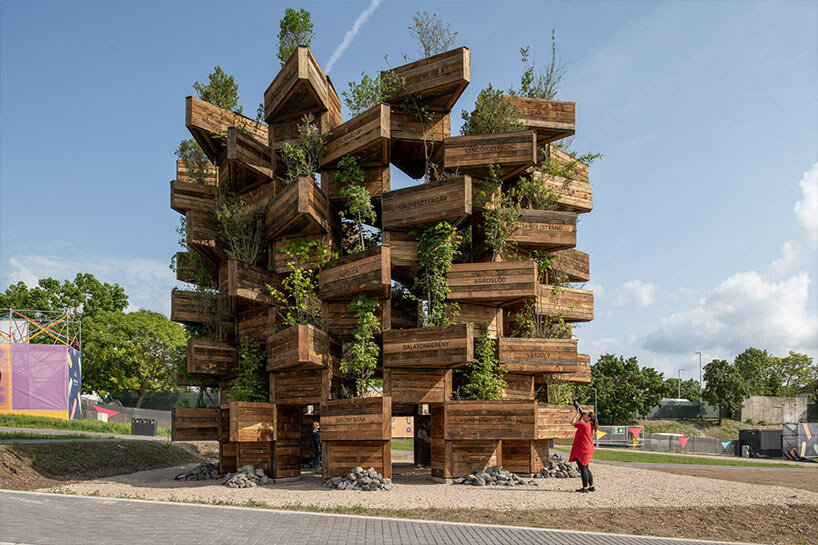 hello wood stacks triangular lush planters for the garden of communities installation
