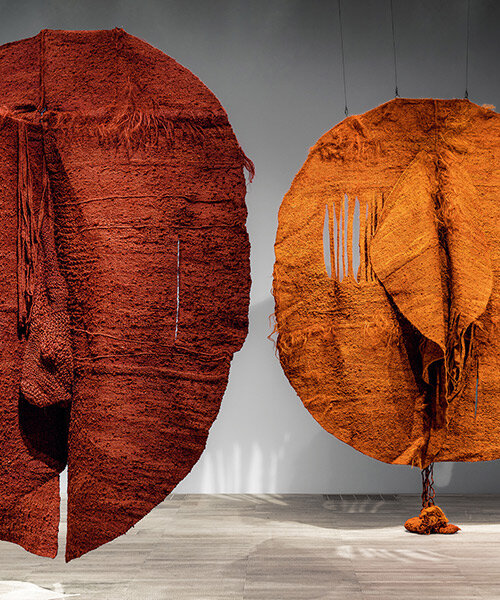 woven biomorphic sculptures by magdalena abakanowicz hover inside MCBA in switzerland