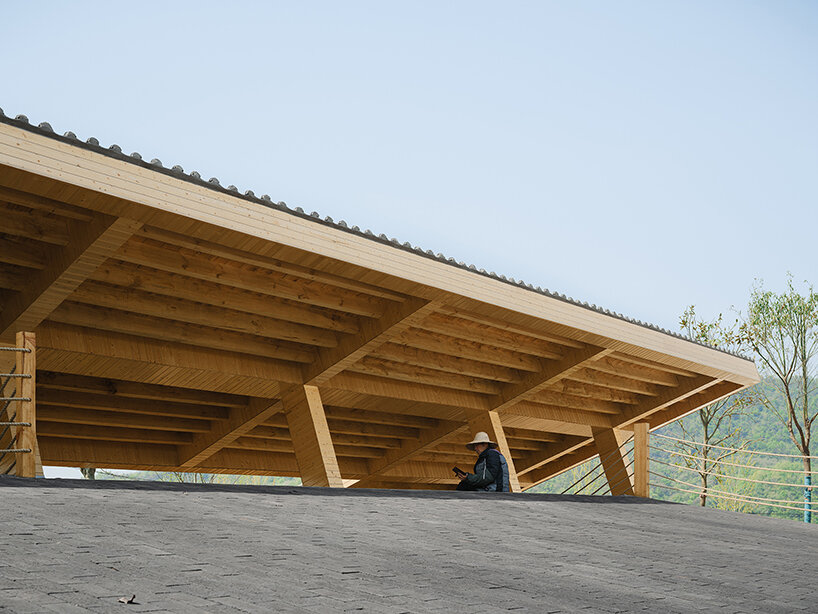topped with a slanted canopy, this pavilion doubles as a viewing platform in rural china
