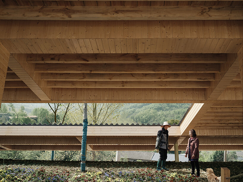 topped with a slanted canopy, this pavilion doubles as a viewing platform in rural china