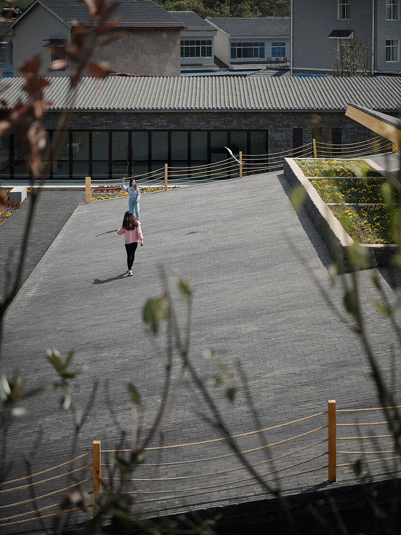 topped with a slanted canopy, this pavilion doubles as a viewing platform in rural china