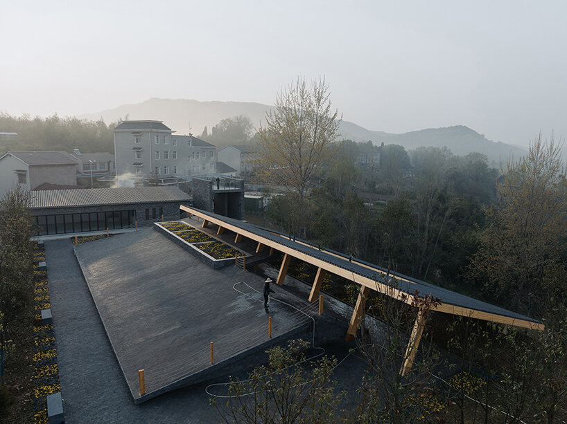 topped with a slanted canopy, this pavilion doubles as a viewing platform in rural china